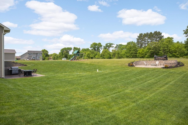 3839 189th Ln NW, Oak Grove, MN 55303 - view of grassy yard with a fire pit, a playground, and a patio