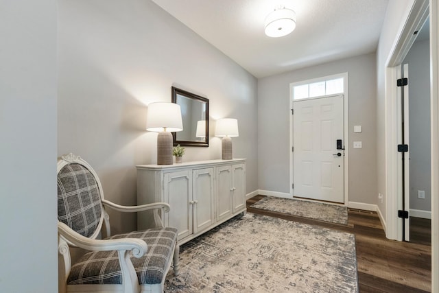 foyer entrance featuring wood finished floors and baseboards