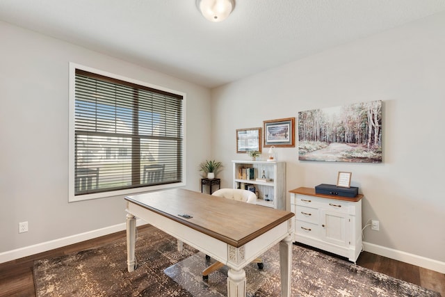 home office featuring baseboards and dark wood-type flooring