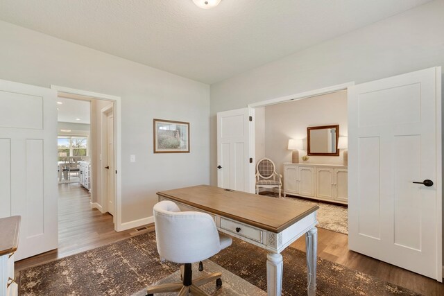 office featuring wood finished floors and baseboards