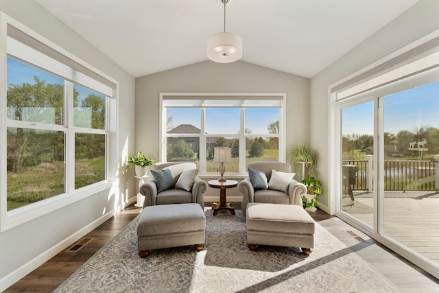 sunroom featuring plenty of natural light and vaulted ceiling