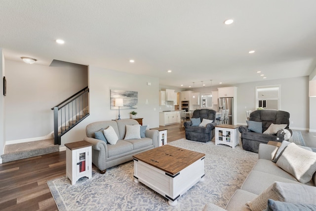 living room with light wood finished floors, stairway, recessed lighting, and baseboards