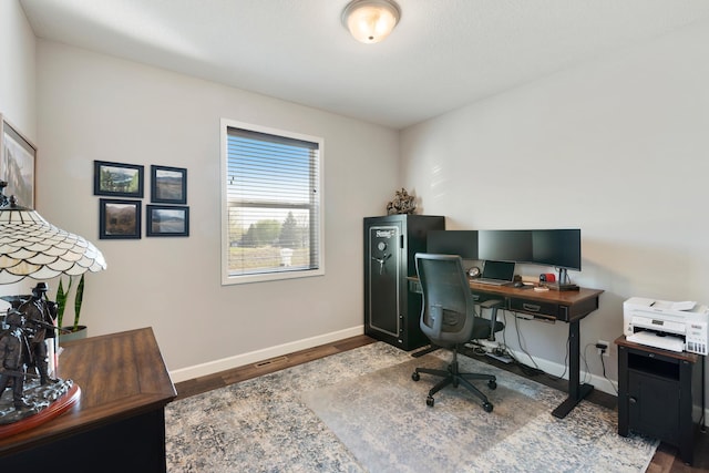 office area featuring baseboards and wood finished floors