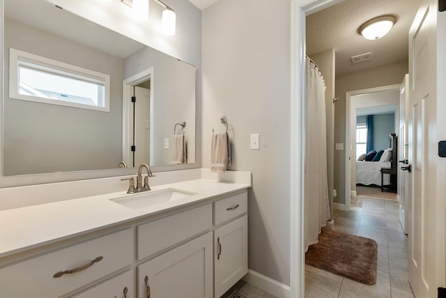 full bath with vanity, tile patterned floors, baseboards, and a shower with shower curtain