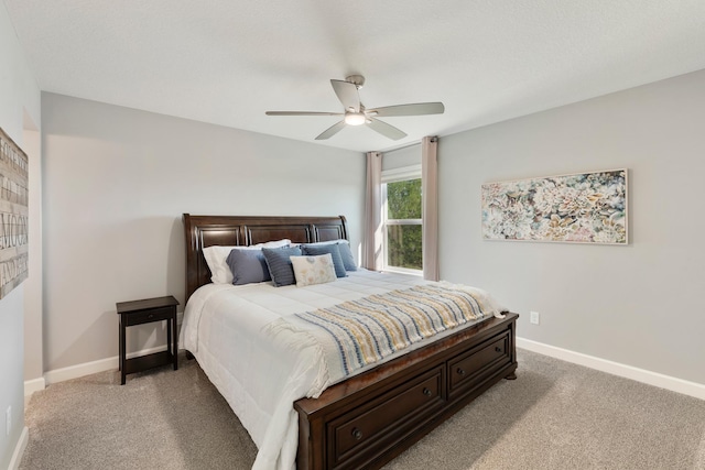 carpeted bedroom with baseboards and ceiling fan