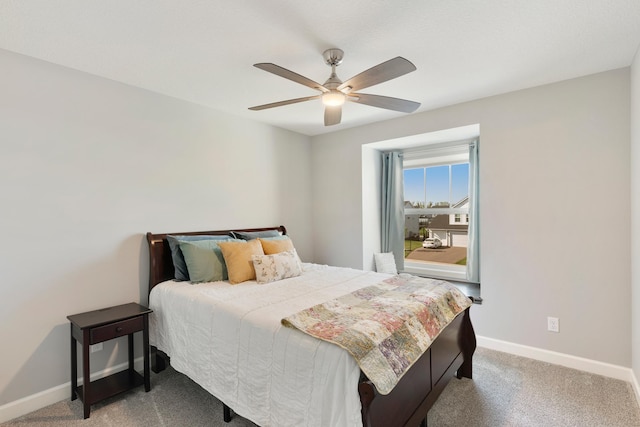 carpeted bedroom with baseboards and a ceiling fan
