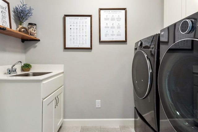 washroom with washer and dryer, cabinet space, and baseboards