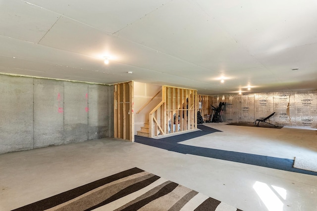 unfinished basement featuring stairway