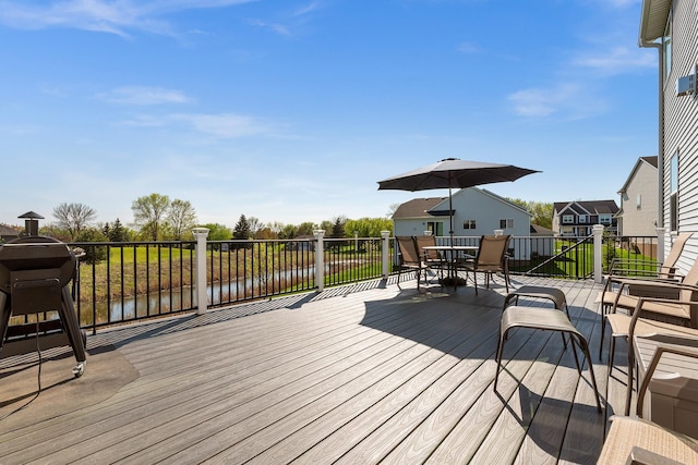wooden terrace with outdoor dining space