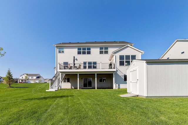 back of property featuring a shed, stairway, a deck, an outdoor structure, and a lawn