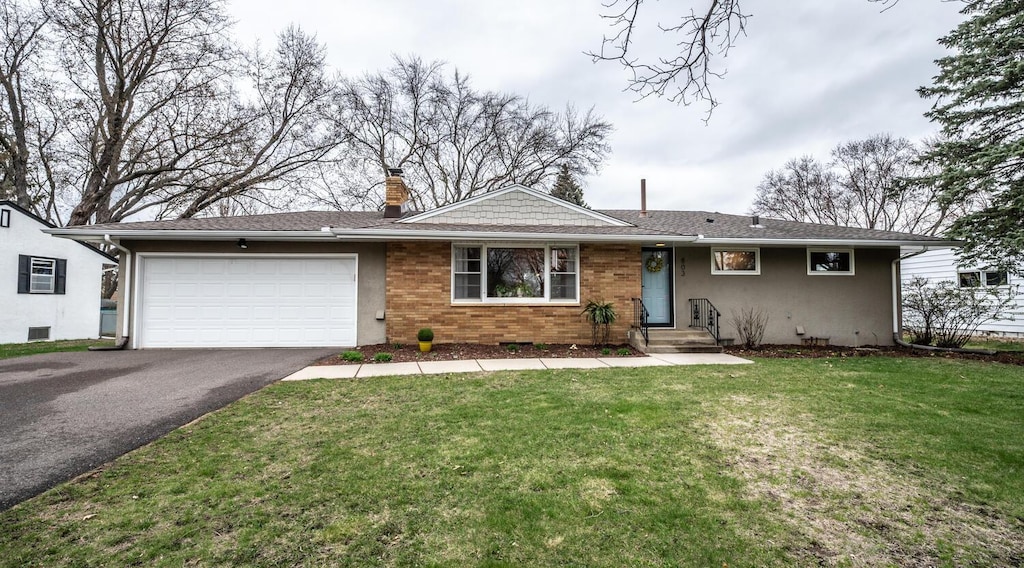 ranch-style house featuring aphalt driveway, a chimney, a garage, a front yard, and stucco siding