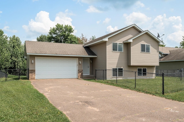 1002 Palomino St, Braham, MN 55006 - split level home featuring concrete driveway, an attached garage, and brick siding