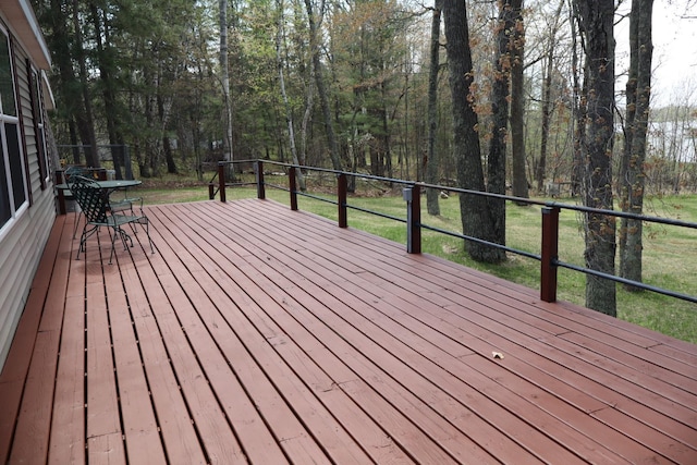 wooden terrace with a lawn