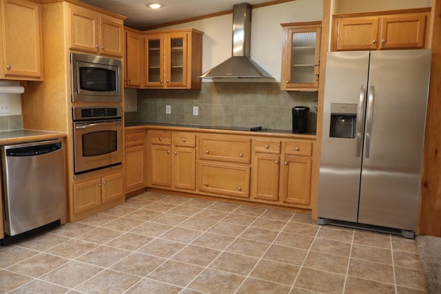 kitchen featuring stainless steel appliances, wall chimney exhaust hood, tile counters, tasteful backsplash, and recessed lighting