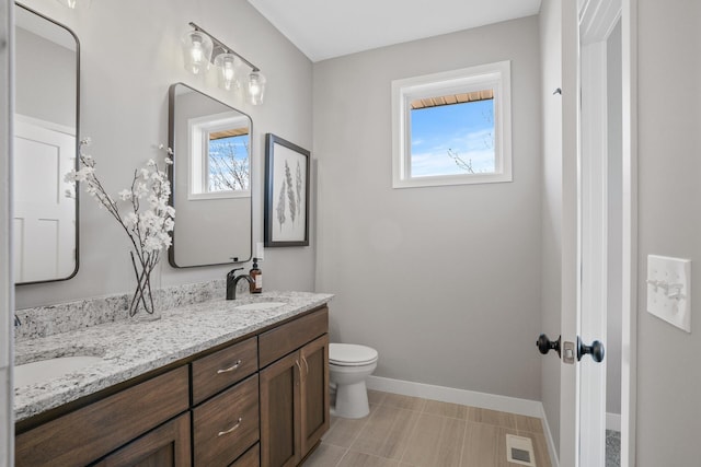 1234 Willowbrook Cir, Delano, MN 55328 - full bathroom with baseboards, visible vents, a sink, and toilet