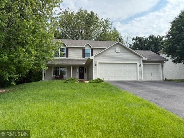 2052 Wilhelm Ct, Shakopee, MN 55379 - view of front facade with an attached garage, driveway, and a front lawn