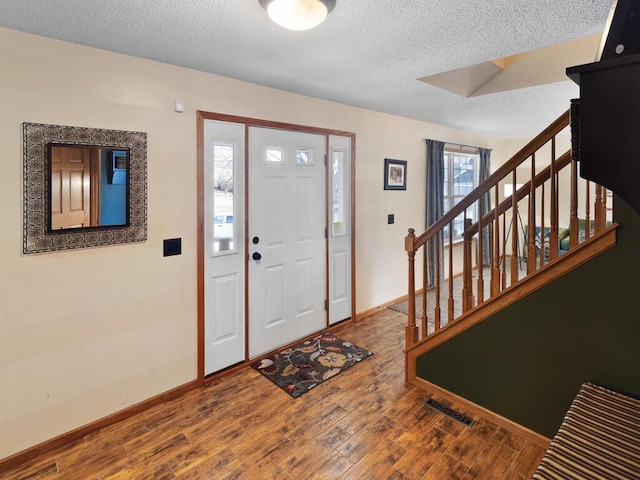 2052 Wilhelm Ct, Shakopee, MN 55379 - entryway with a textured ceiling, baseboards, stairs, and wood finished floors