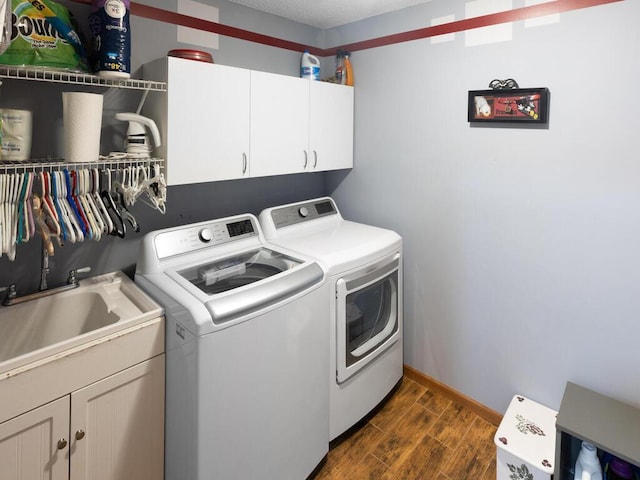 2052 Wilhelm Ct, Shakopee, MN 55379 - laundry area featuring washing machine and clothes dryer, cabinet space, dark wood-style floors, and baseboards