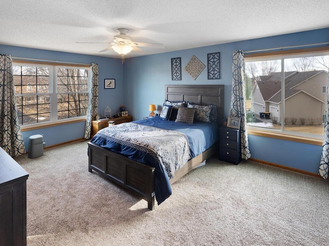 2052 Wilhelm Ct, Shakopee, MN 55379 - carpeted bedroom with multiple windows, baseboards, a textured ceiling, and a ceiling fan