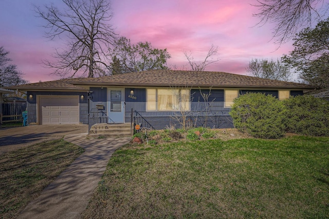 ranch-style house featuring an attached garage, a front lawn, and concrete driveway