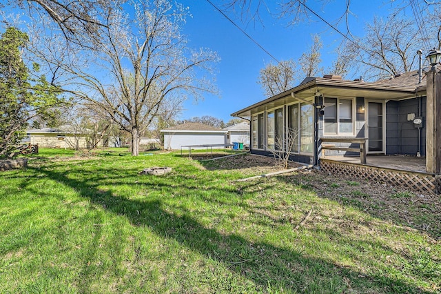 view of yard with a sunroom and a deck