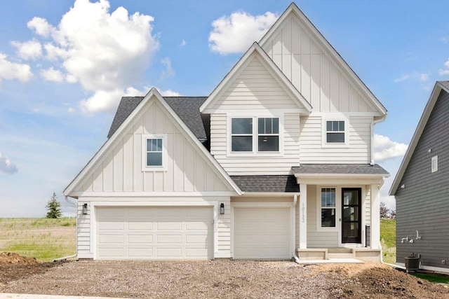 view of front of property featuring driveway, roof with shingles, board and batten siding, and a garage
