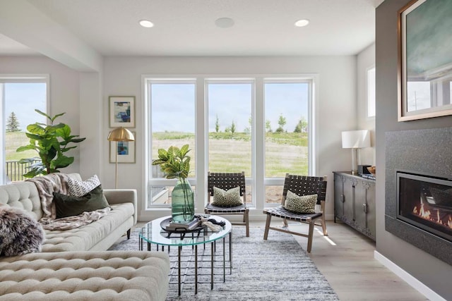 living room with light wood-type flooring, plenty of natural light, and recessed lighting