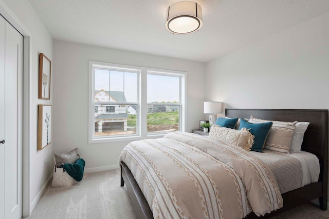 carpeted bedroom featuring baseboards