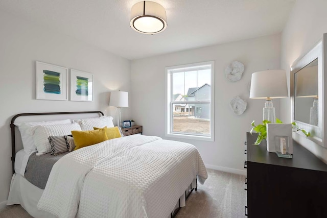carpeted bedroom with baseboards