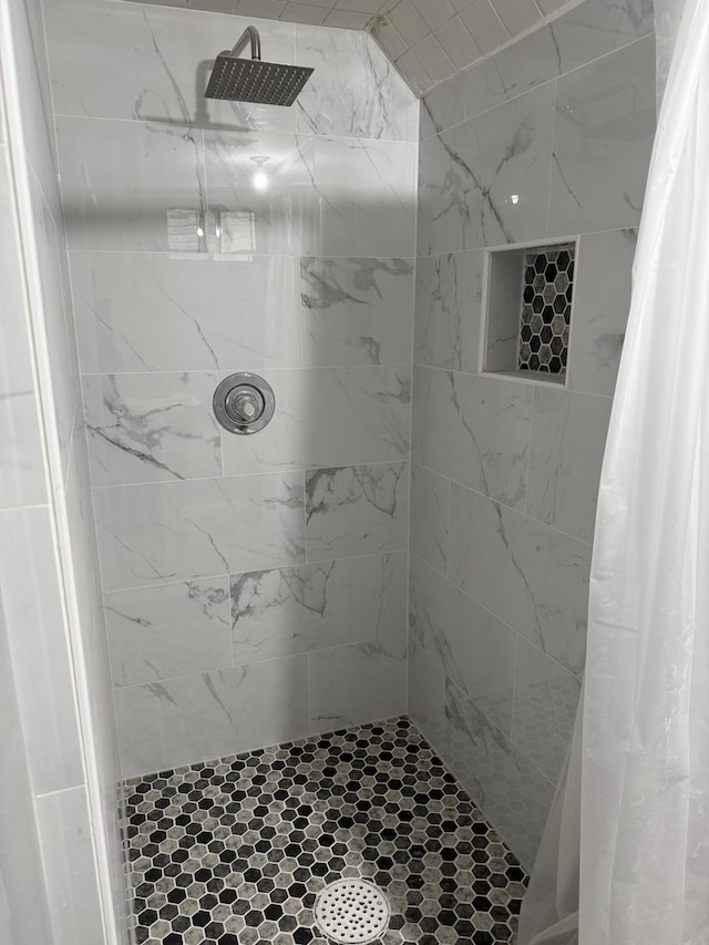 bathroom with a tile shower