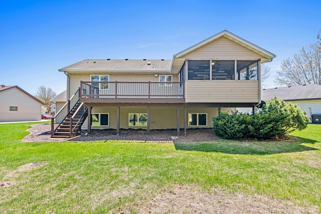back of property with stairway, a deck, a yard, and a sunroom