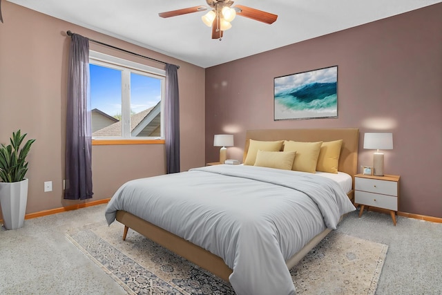 carpeted bedroom with baseboards and ceiling fan