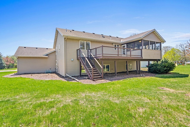 back of property with a sunroom, stairs, a deck, a lawn, and central AC