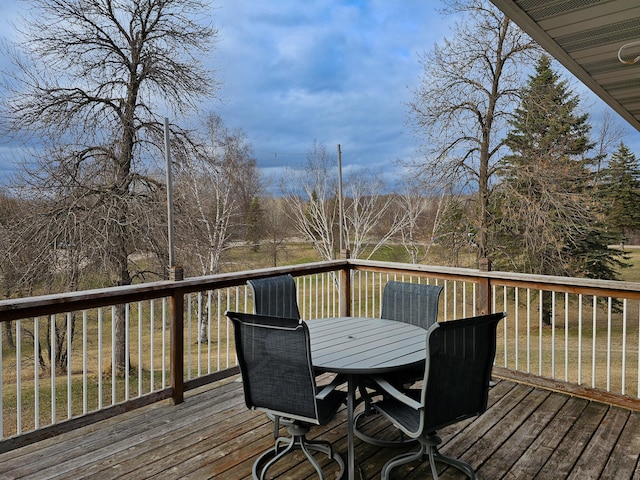 wooden terrace with outdoor dining space