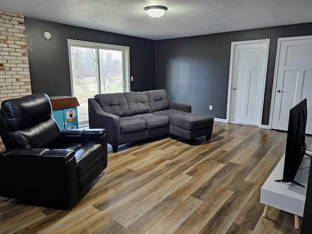 living room with a textured ceiling and wood finished floors