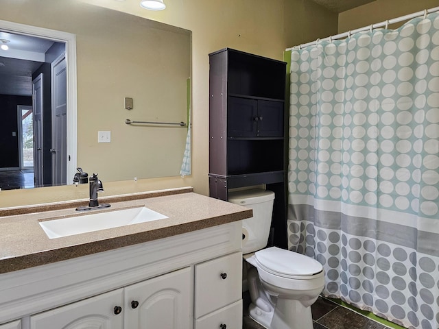 bathroom featuring toilet, a shower with curtain, and vanity
