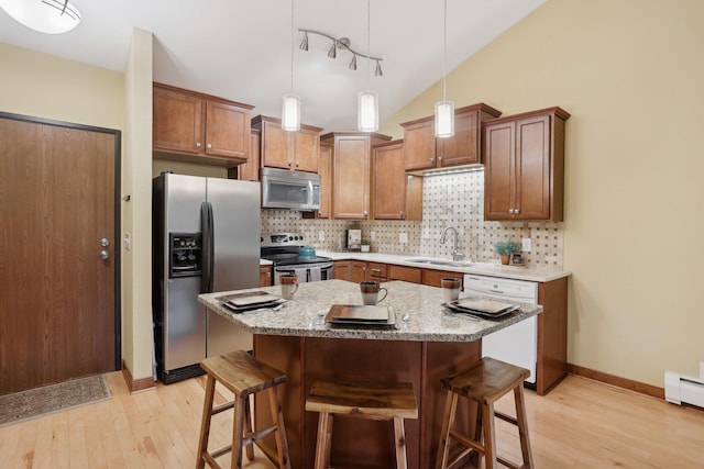 3850 Plymouth Blvd Unit 318, Plymouth, MN 55446 - kitchen featuring light wood-type flooring, a sink, appliances with stainless steel finishes, and a kitchen breakfast bar