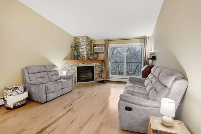 3850 Plymouth Blvd Unit 318, Plymouth, MN 55446 - living room featuring a wall mounted air conditioner, wood finished floors, and a fireplace