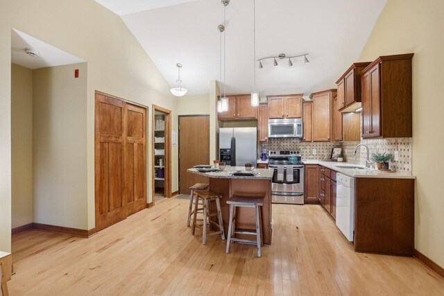 3850 Plymouth Blvd Unit 318, Plymouth, MN 55446 - kitchen with a sink, light wood finished floors, a center island, stainless steel appliances, and a kitchen bar