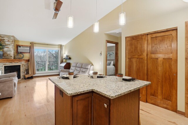 3850 Plymouth Blvd Unit 318, Plymouth, MN 55446 - kitchen with lofted ceiling, open floor plan, a baseboard heating unit, a wall unit AC, and light wood finished floors