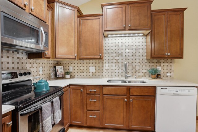 3850 Plymouth Blvd Unit 318, Plymouth, MN 55446 - kitchen featuring a sink, light countertops, decorative backsplash, and stainless steel appliances