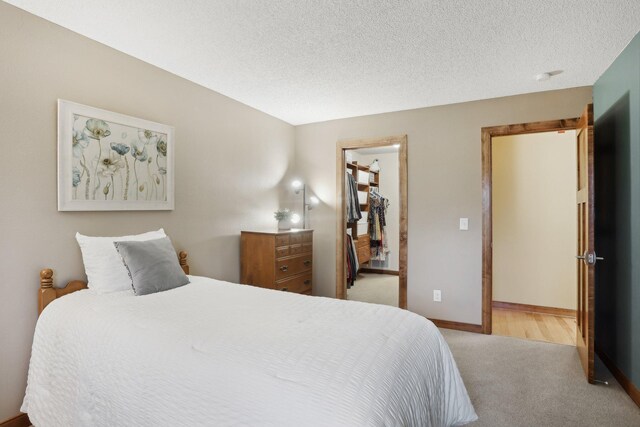 3850 Plymouth Blvd Unit 318, Plymouth, MN 55446 - carpeted bedroom with a textured ceiling and baseboards