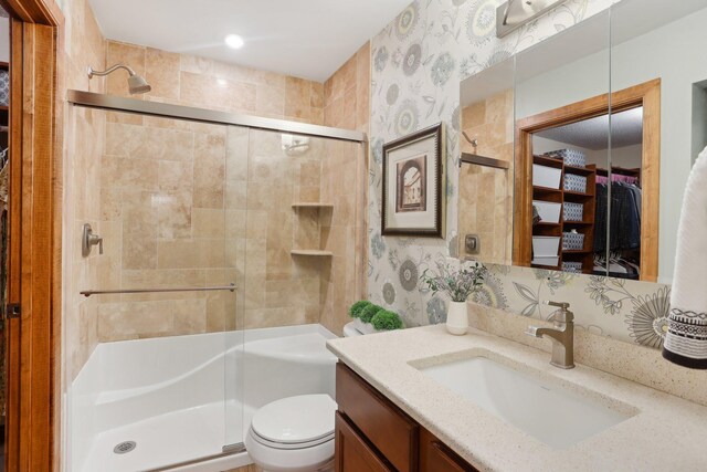 3850 Plymouth Blvd Unit 318, Plymouth, MN 55446 - bathroom featuring toilet, wallpapered walls, a shower stall, and vanity