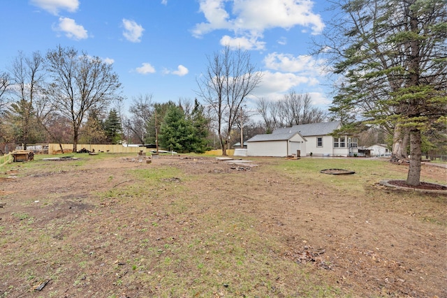 view of green lawn featuring an outdoor fire pit