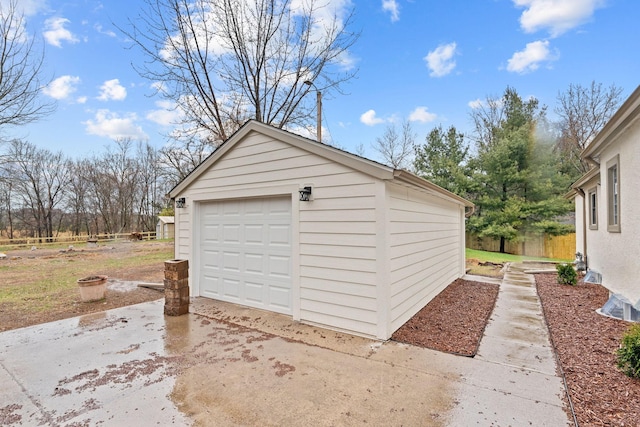 detached garage featuring driveway