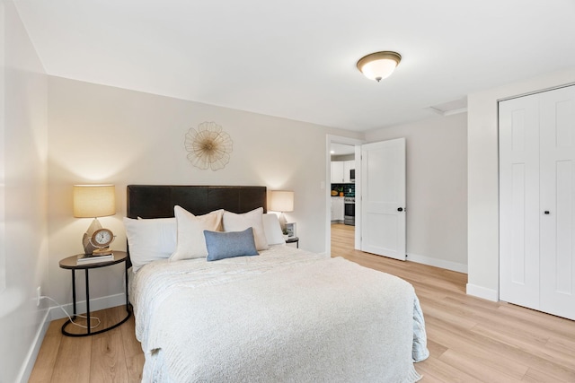 bedroom with baseboards and light wood-style flooring