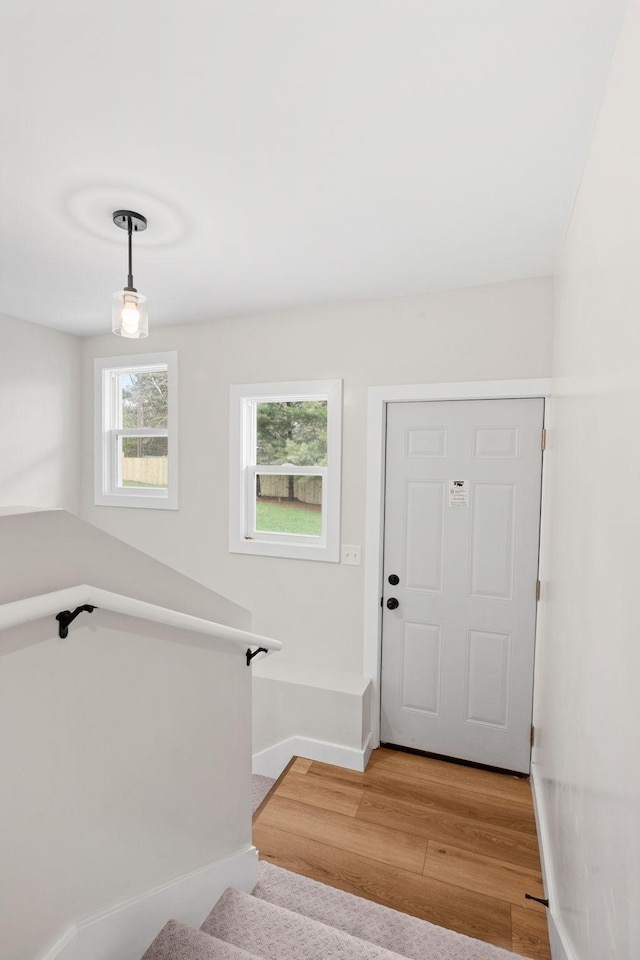 entrance foyer with light wood finished floors and baseboards