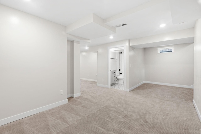 finished basement featuring light carpet, recessed lighting, and baseboards