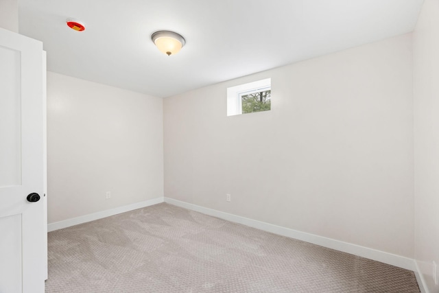 empty room with carpet and baseboards