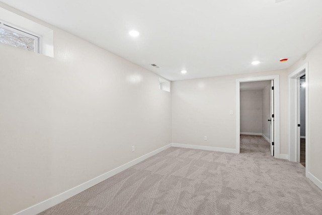 unfurnished room with light carpet, baseboards, and recessed lighting